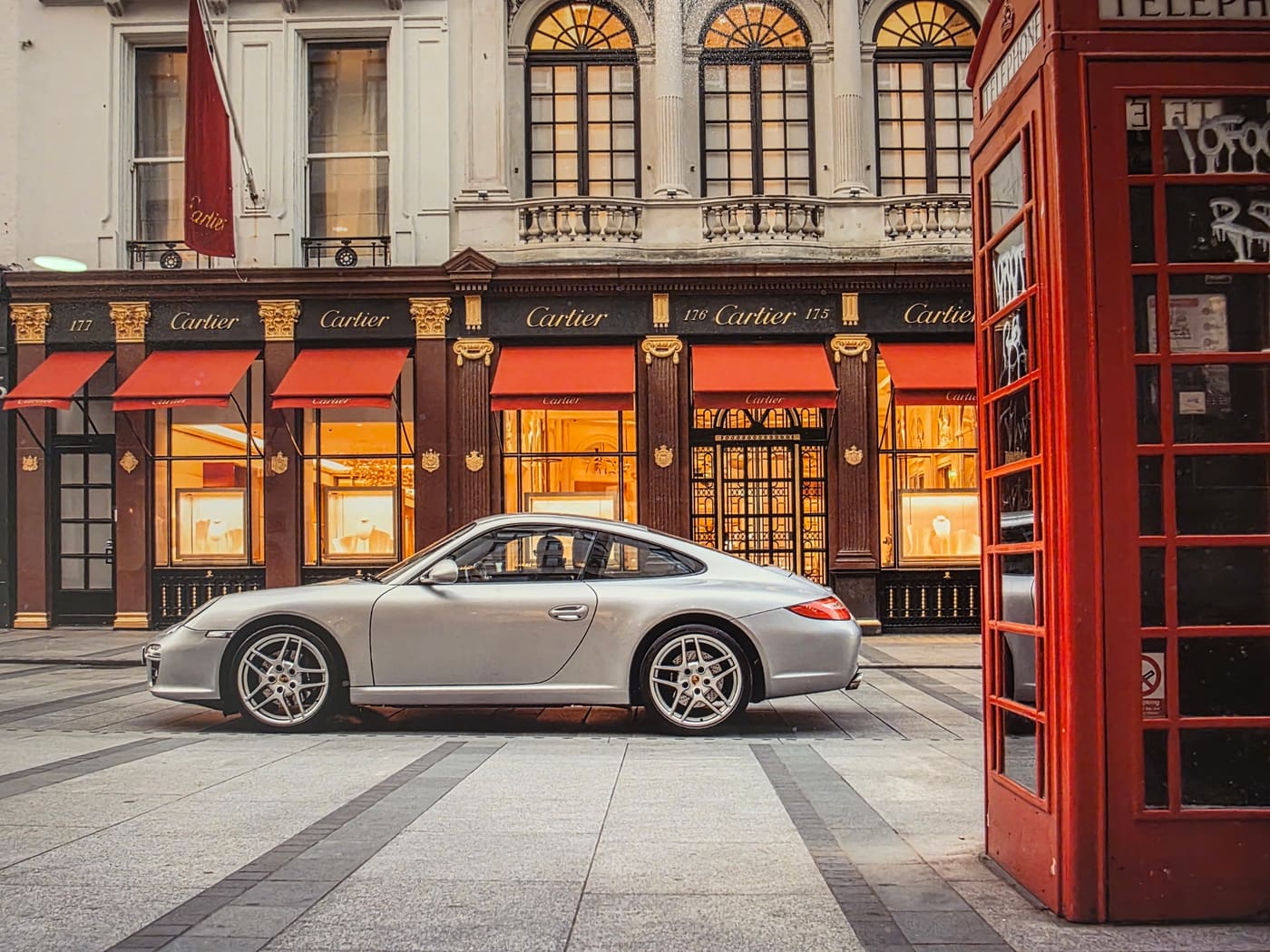 Silver Porsche 911 parked outside Cartier on Bond Street, London