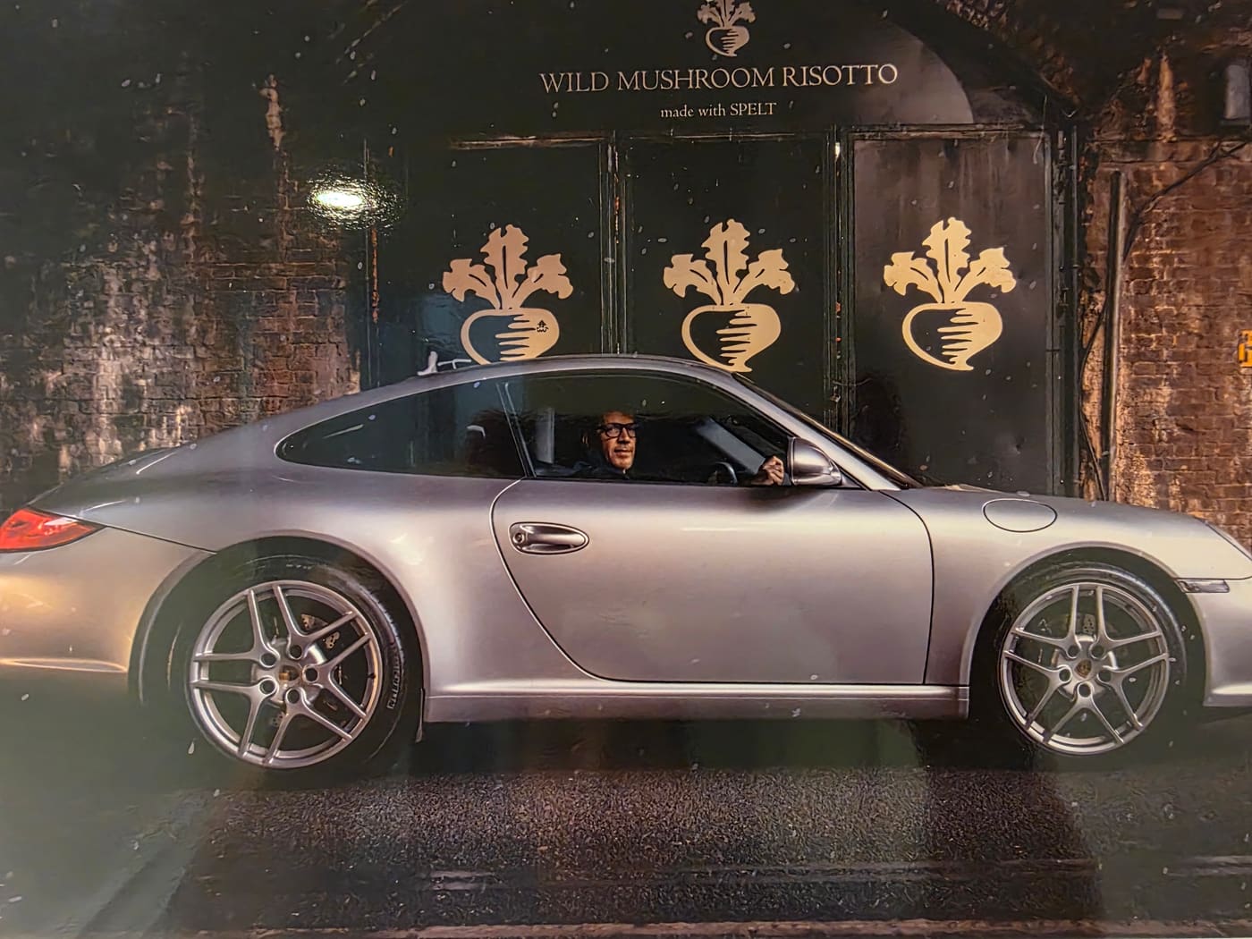 Scott at the wheel of his Porsche 911 under a Borough Market archway